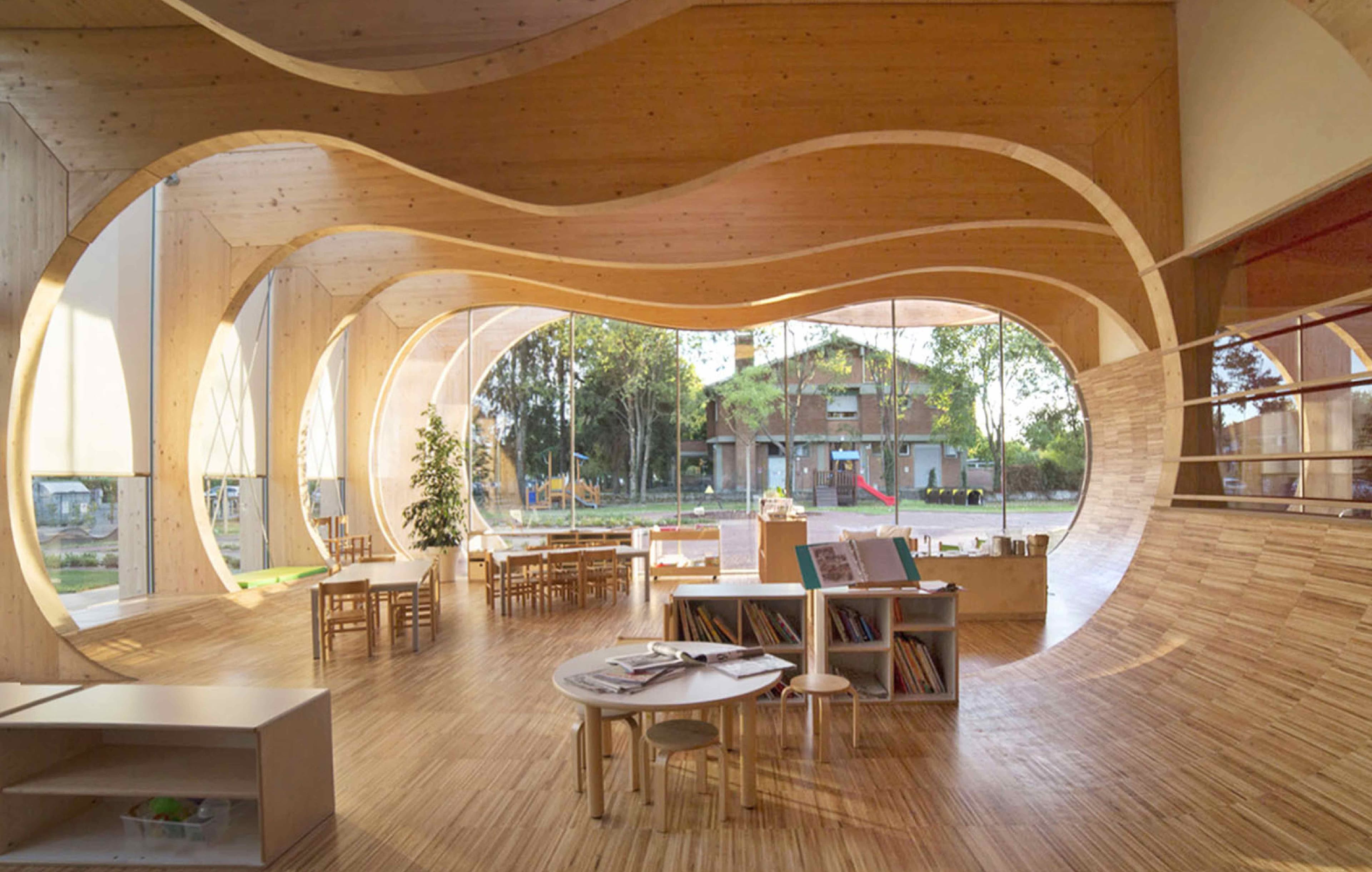 An organically designed Montessori environment with cabinets and chairs in a light space.
